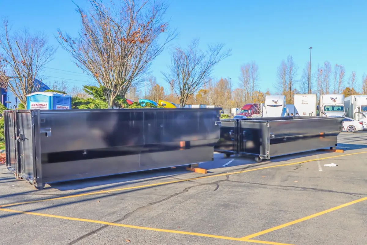 Professional dumpster rental service with roll-off container on residential driveway in Somerdale